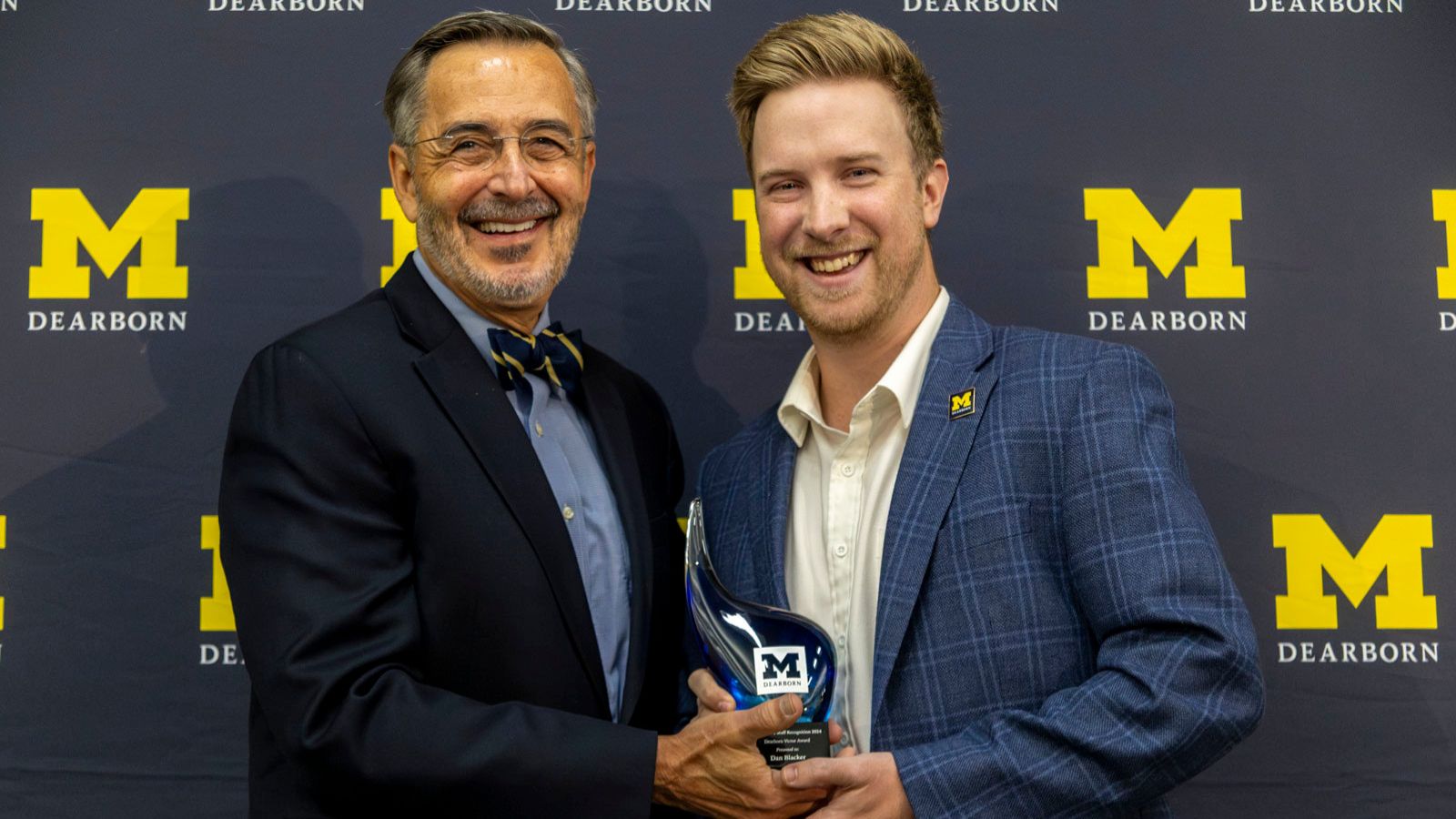 Dan Blacker receives his Dearborn Victor award from Chancellor Grasso