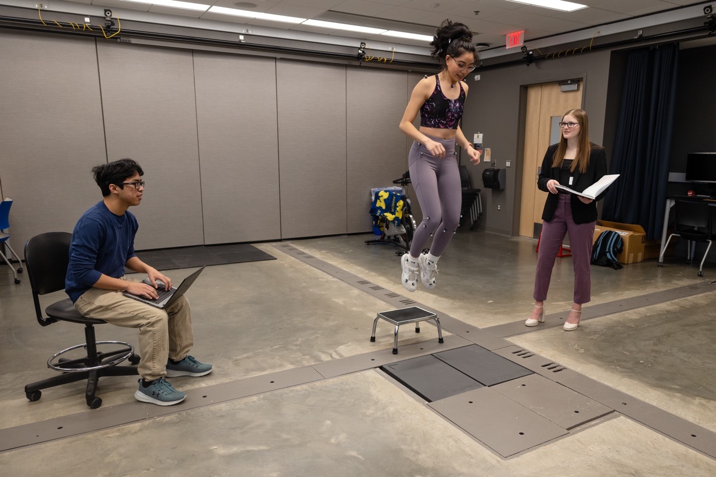 three students testing body sensors at the engineering lab