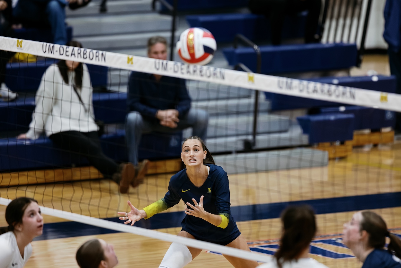 A focused female volleyball player gets ready to hit the ball