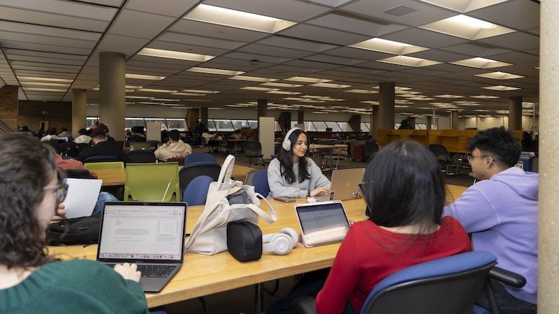 Students working around a table in the Library