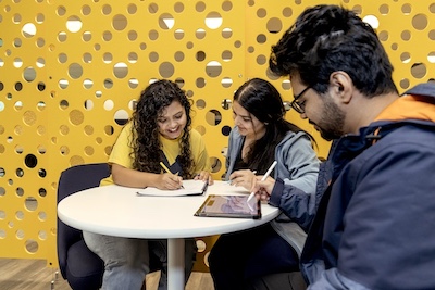 Students working and studying around a desk in RUC