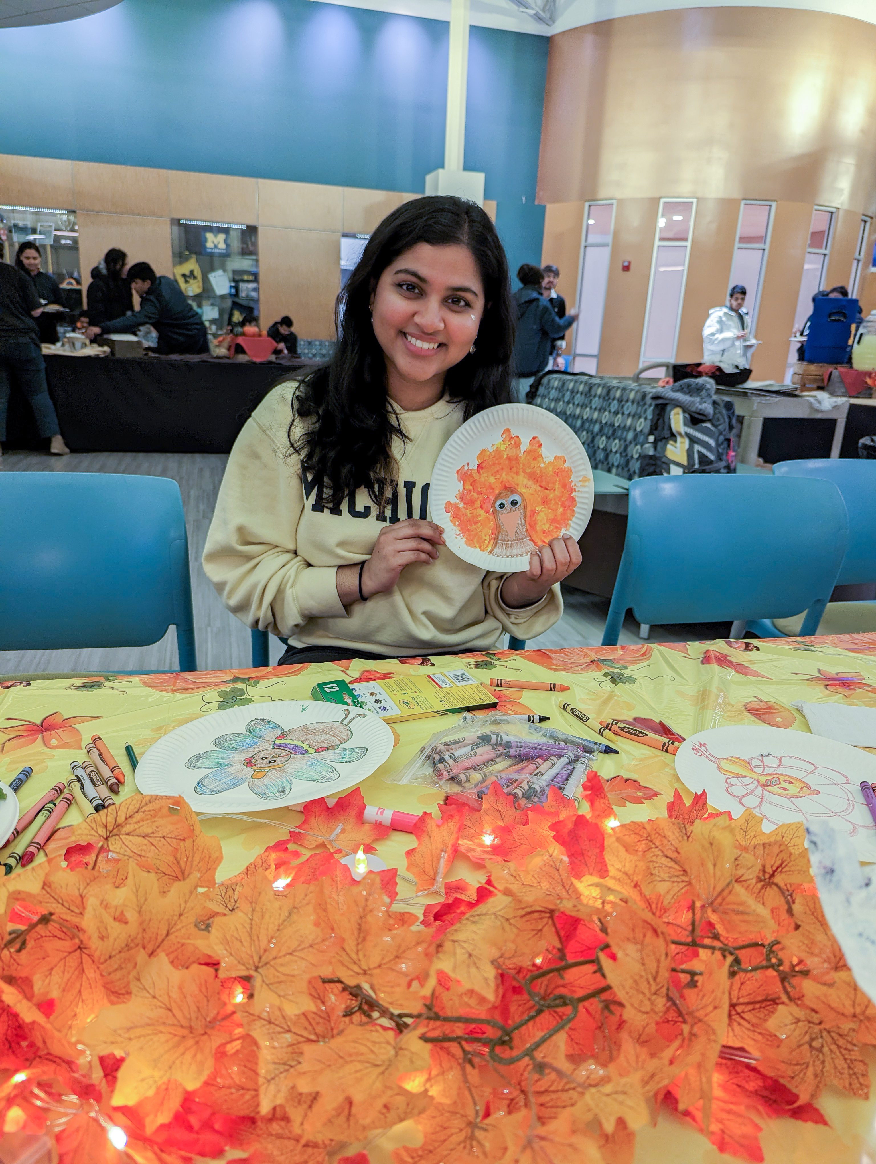 Sophomore Gayathri Chava makes DIY Thanksgiving decorations at the 2022 UM-Dearborn Friendsgiving
