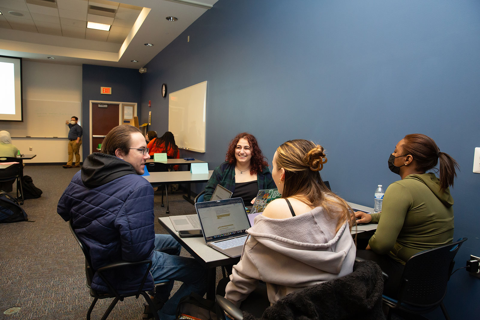 Students in a group during class lecturer