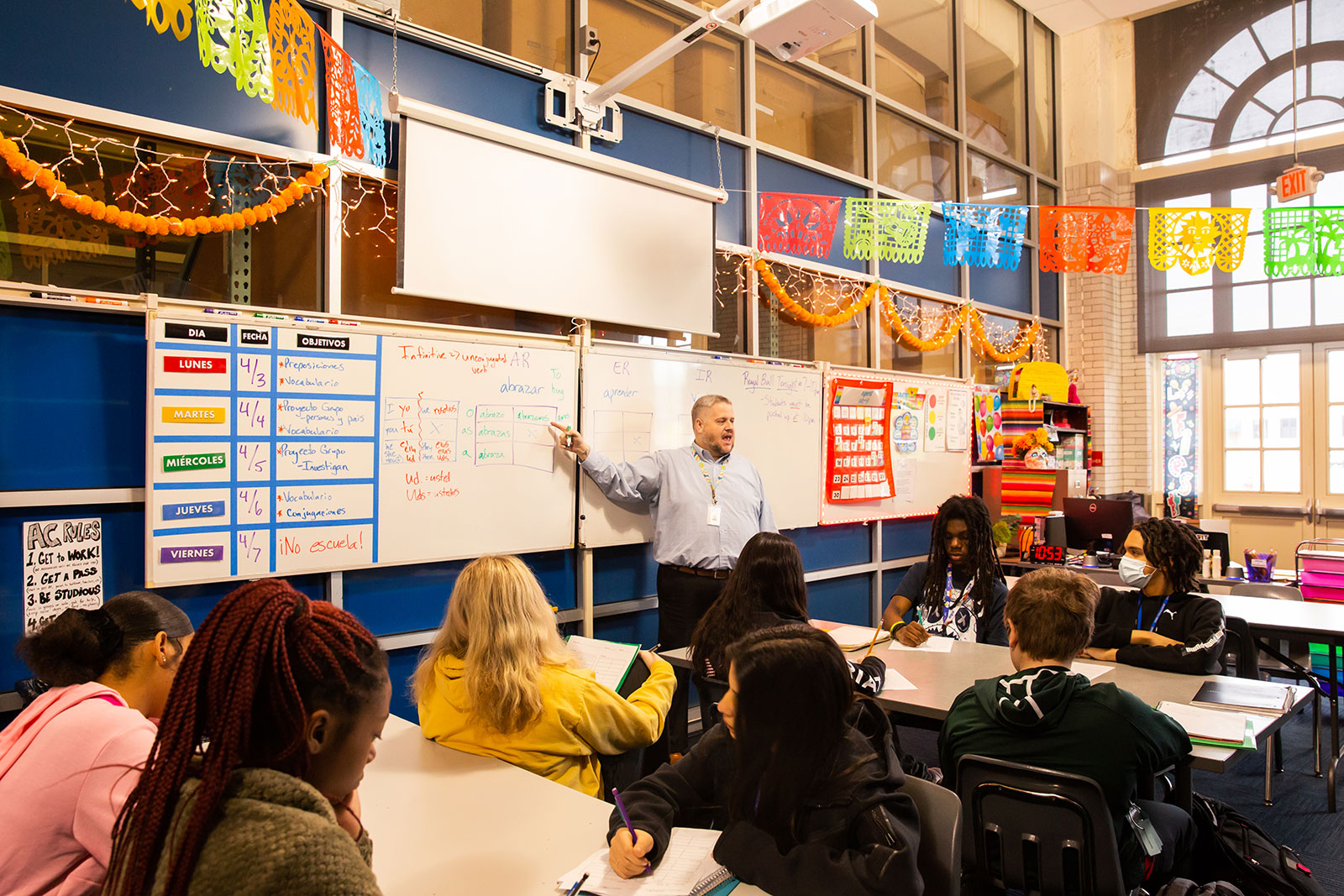 Student teacher teaching students in a classroom.