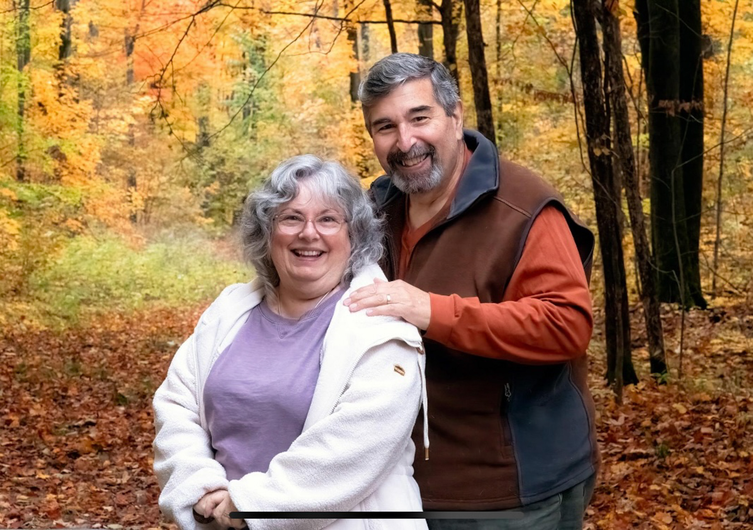 Dennis and Lorna Kurtjian pose for a family portrait on a fall day