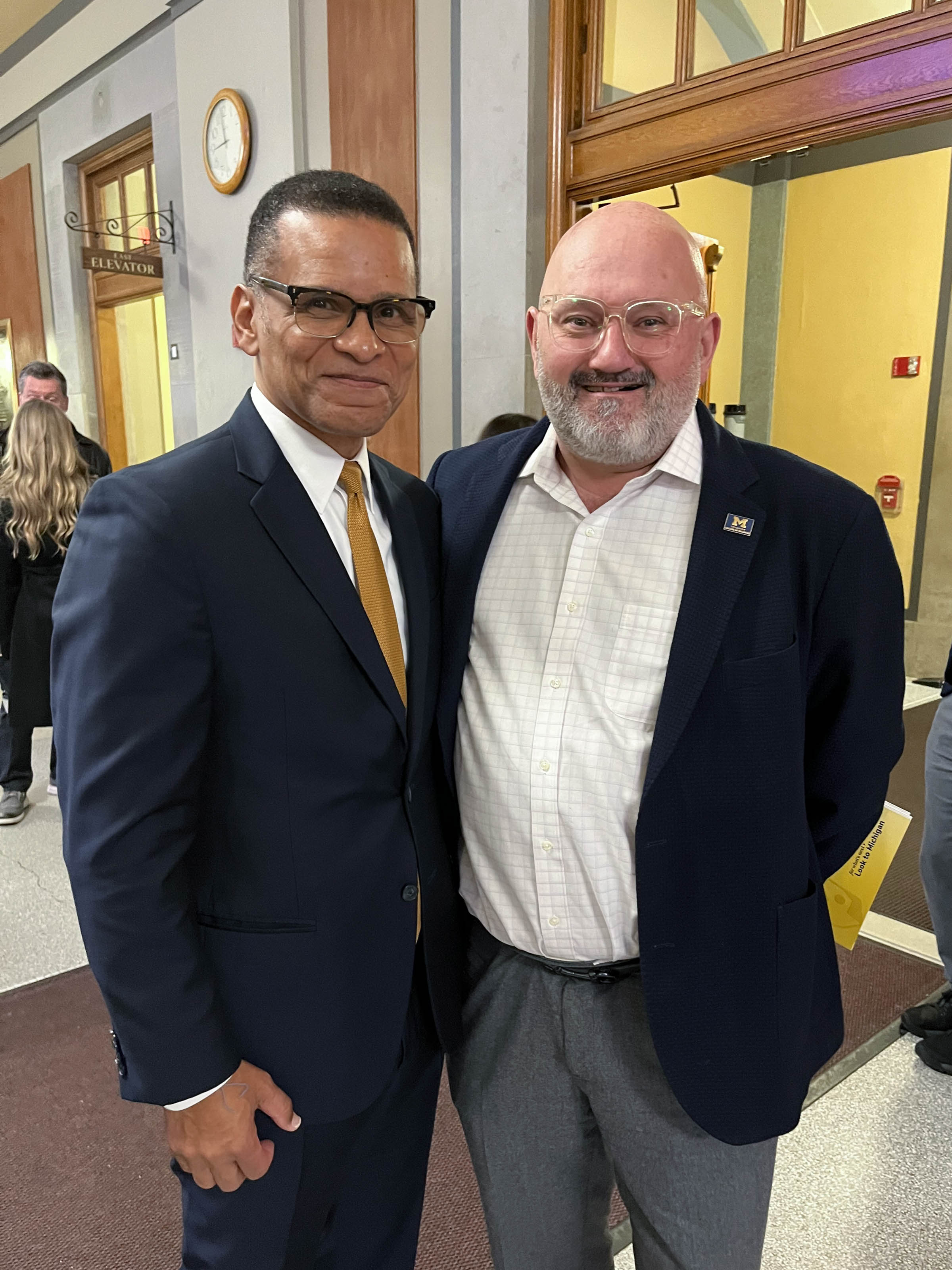 '03 alum Anthony Williams and COB Dean Frederic Brunel pose for a photo at an event