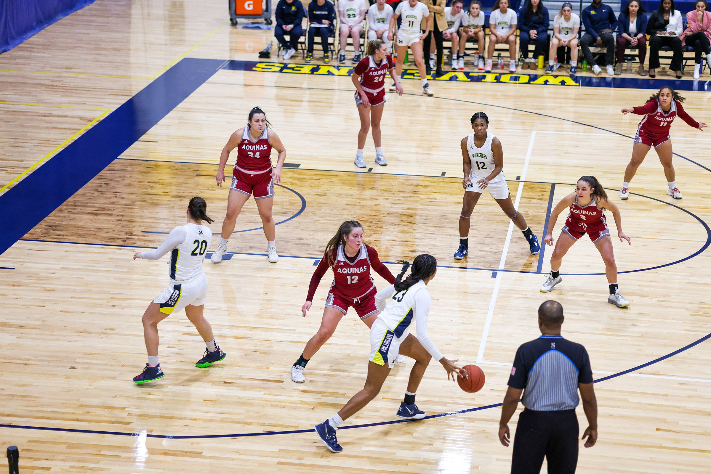 The women's basketball team playing Aquinas College on the new hardwood floor at the UM-Dearborn Fieldhouse