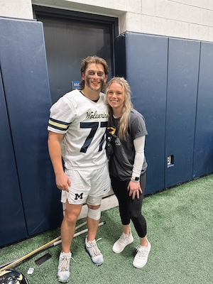 Cadence Pero and Colin Garner pose for a photo at a U-M athletic facility