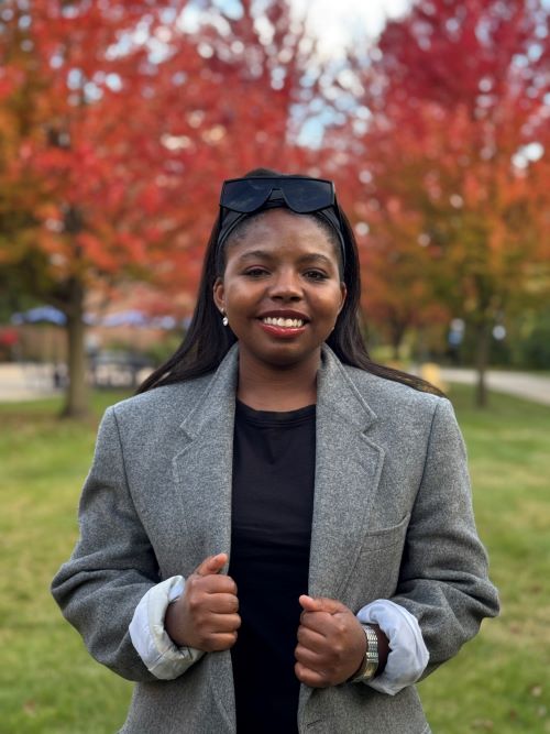 CASL transfer student Bryanna Worthy stnading in from of fall landscape on outdoor campus.