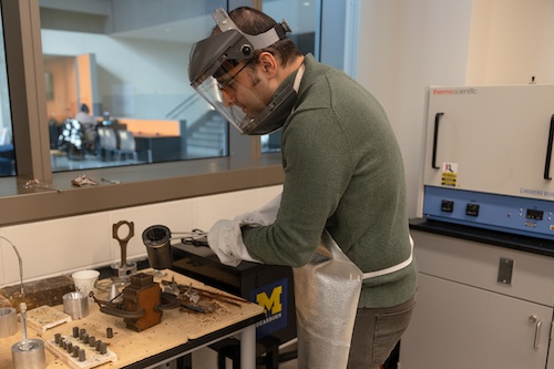 Student working in lab wearing protective equipment