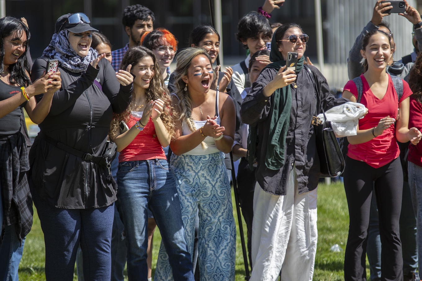 Group of students cheering loudly and clapping