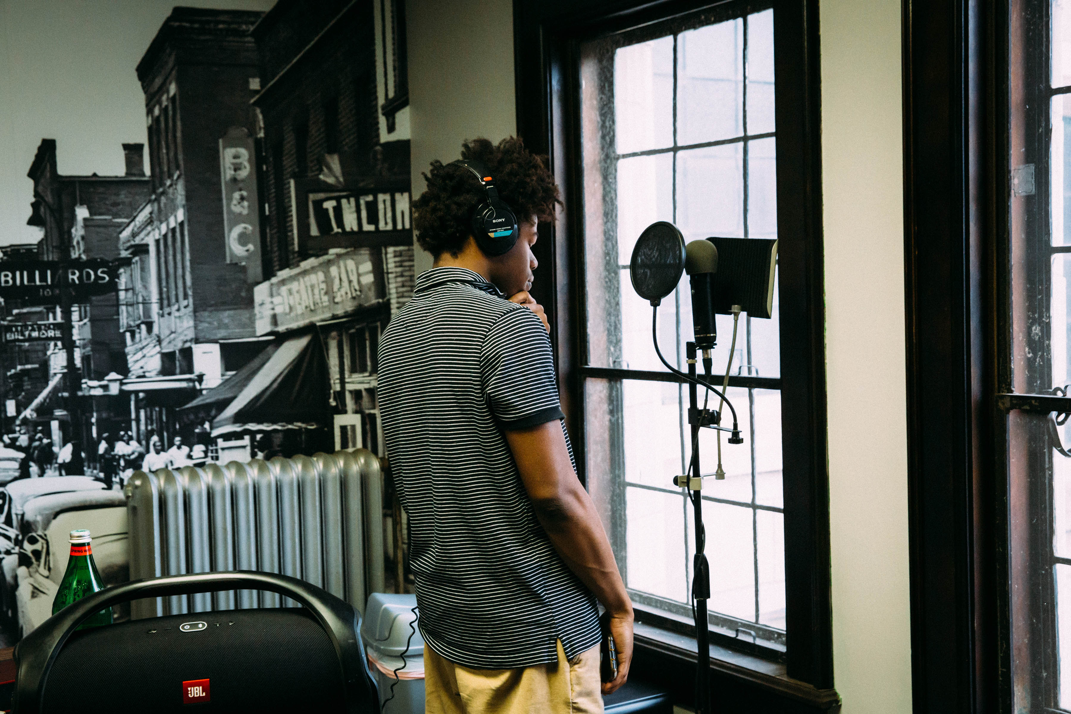 A student stands pensively, preparing to record his song in the pop-up studio at the Marygrove campus.
