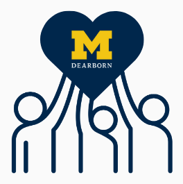 Three people holding up a hear that says Um-Dearborn