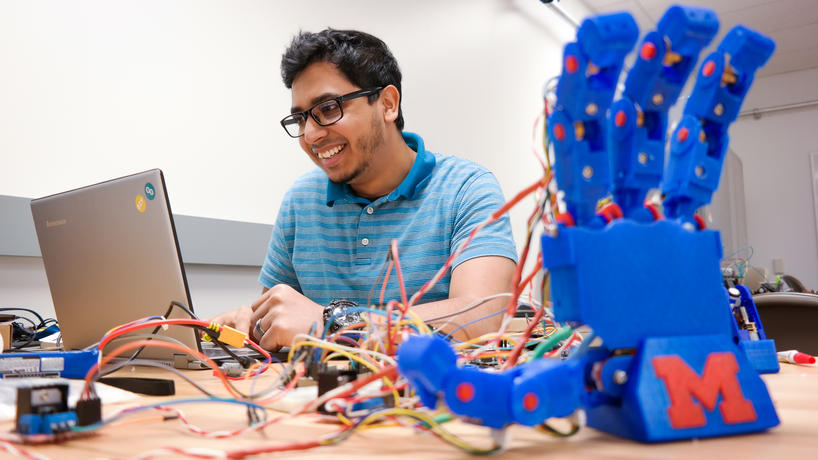 Mechanical engineering master's degree student Safwan Ul Ferdous works on a low-cost humanoid robotic hand in Assistant Professor Yu Zheng's electrical engineering lab.