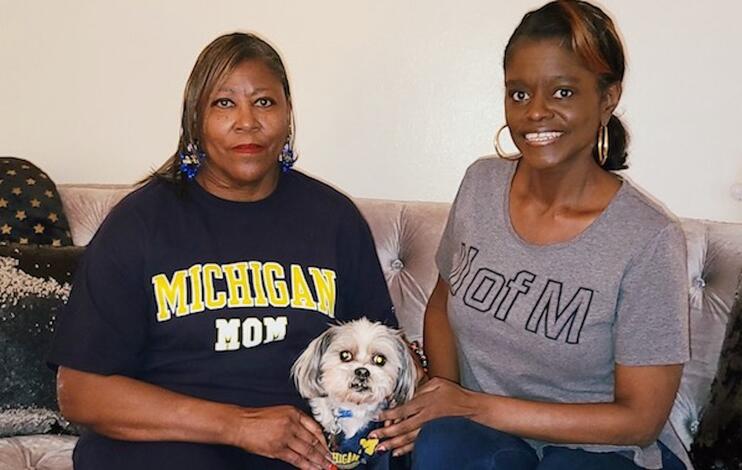 Fall 2020 graduate Sharon Harris, right, with her mom Sandra and dog Cody. Sharon said her mom inspired her to return to school.