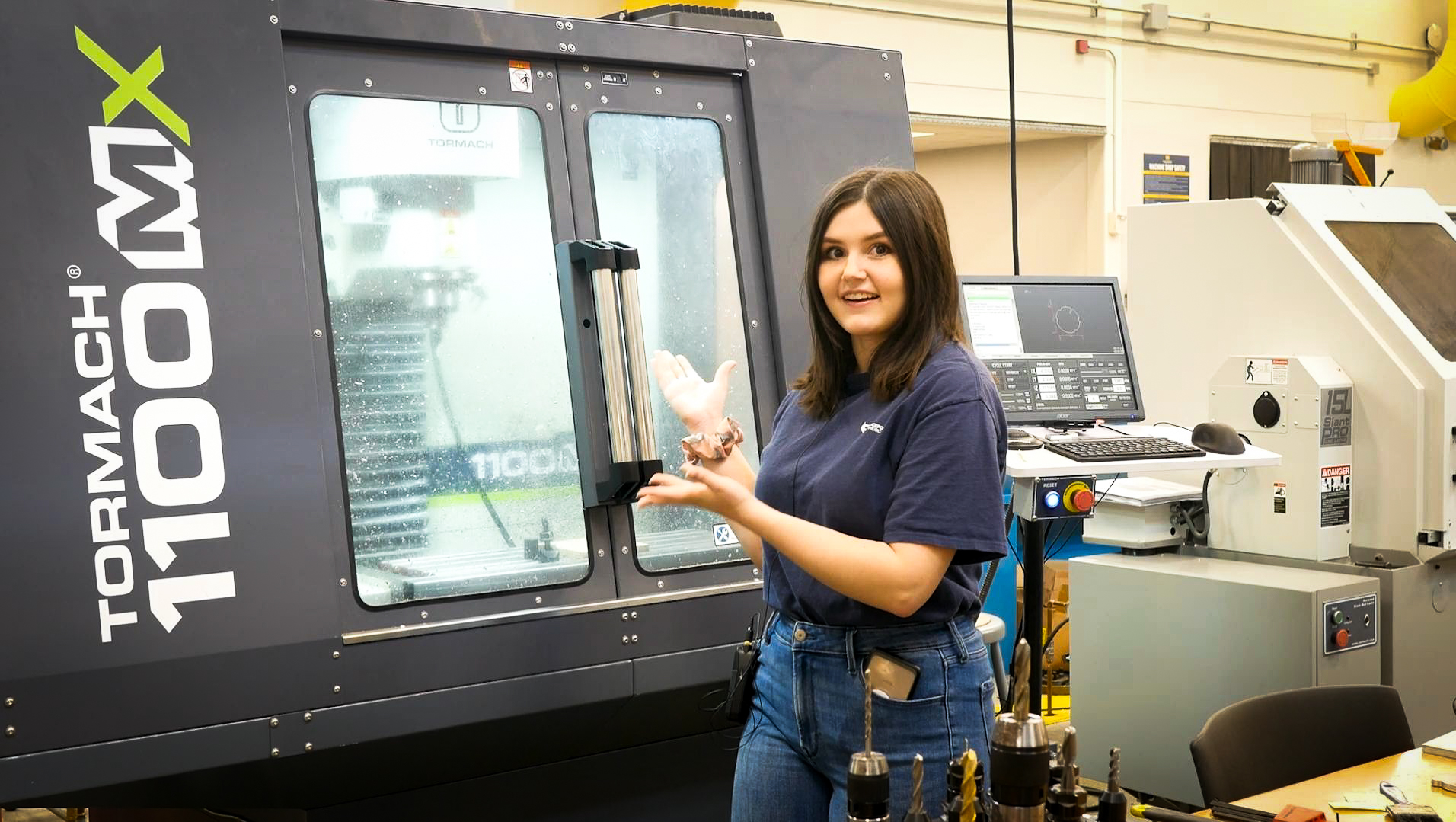 Mechanical engineering senior Sierra Stockwell stands next to the Tormach CNC mill, one of her favorite tools in the MSEL.