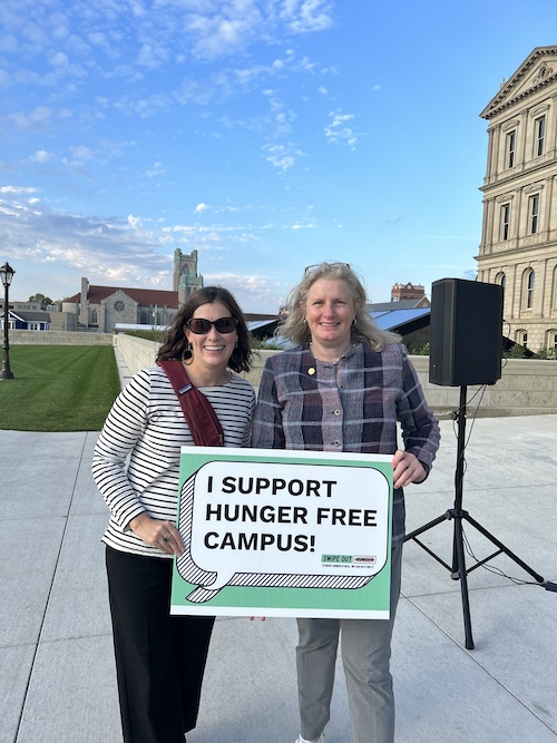 Sociology professor Carmel Price holding sign that reads I support Hunger Free Campus!
