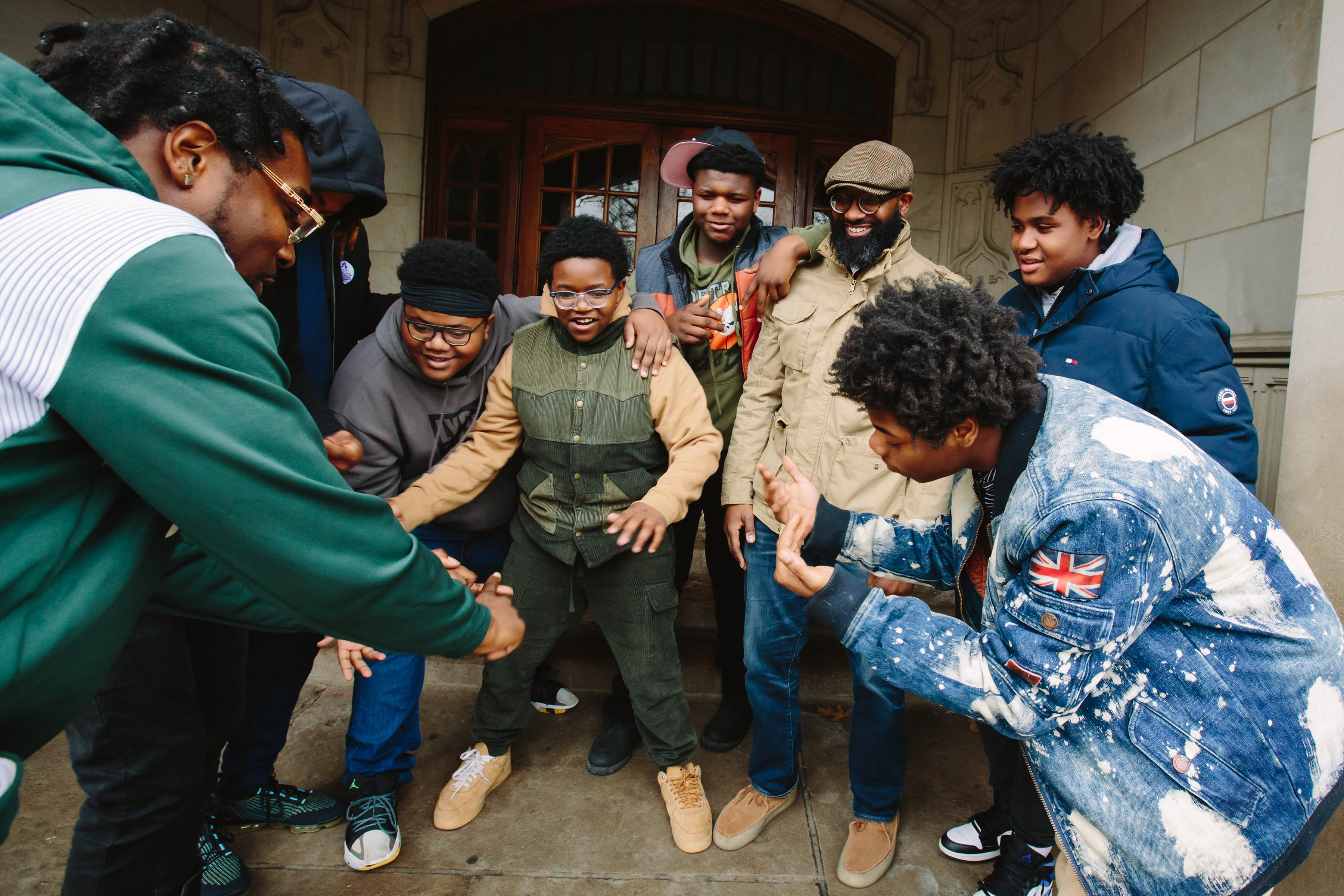A group of students having a good time, rapping outside a historic building on the Marygrove College campus. 
