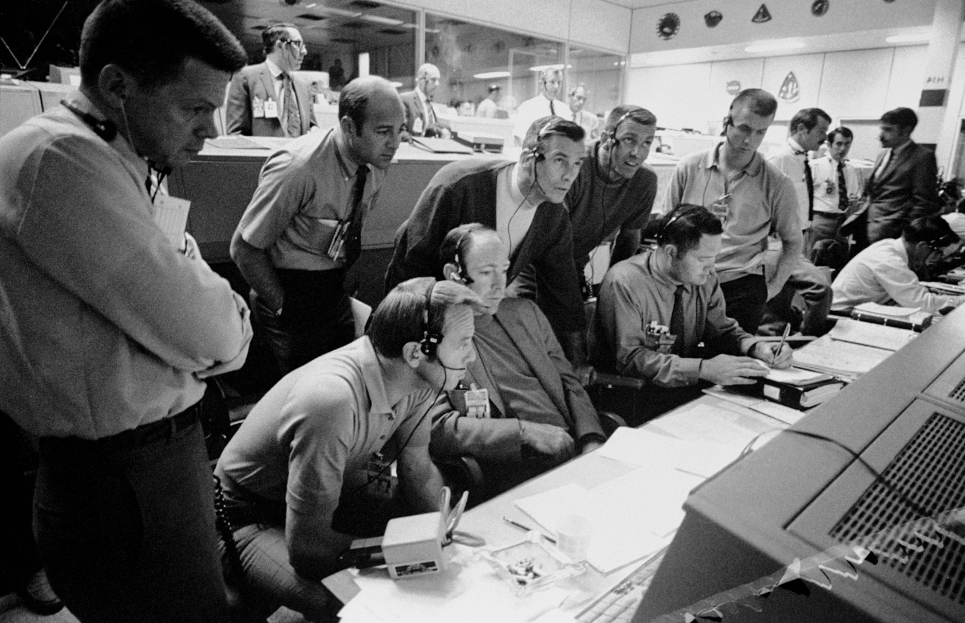 Men gather in the Mission Control Room in Houston during the third day of the Apollo 13 mission