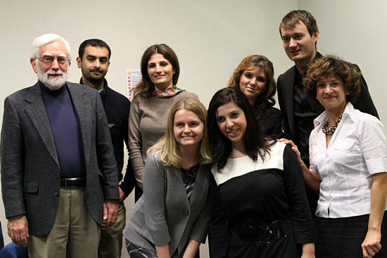 Political science Prof. Ron Stockton (far left) poses with seven of the UM-Dearborn students and alumni who participated in a recent project in which they shared their own immigrant memoirs.