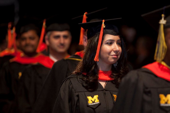 Students dressed in graduation gowns with UM-Dearborn