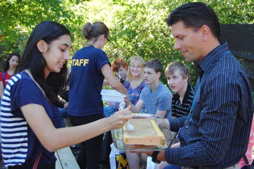 David Susko, director of the Environmental Interpretive Center, serves up some  honey fresh from a campus beehive