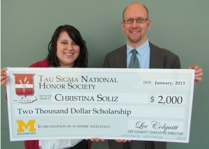 Christina Soliz received her check from chapter adviser Christopher Tremblay