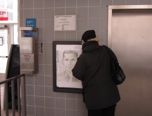 Before stepping onto the elevator, a People Mover rider admires the charcoal and graphite portrait of President Barack Obama drawn by Joshua Johnson, a junior at Douglass Academy for Young Men in Detroit. Johnson created the image for a Black History Month project facilitated by Associate Professor Julie Taylor.