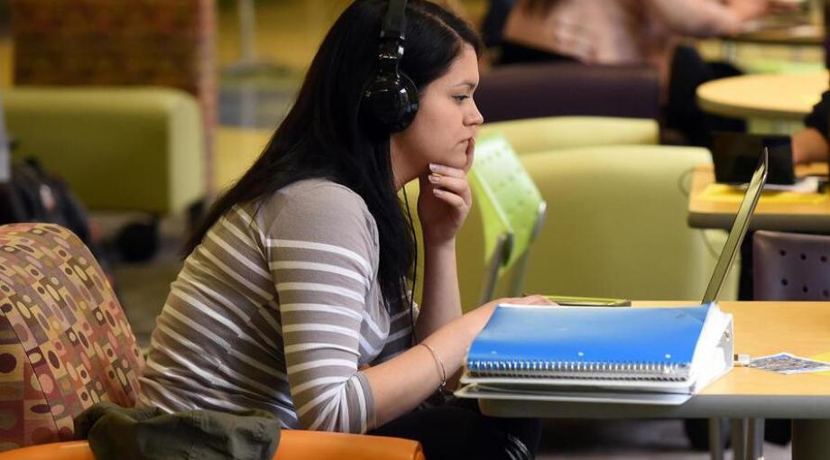 Student studying with her headphones.