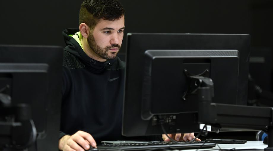 This is an image of a graduate student working on a computer.