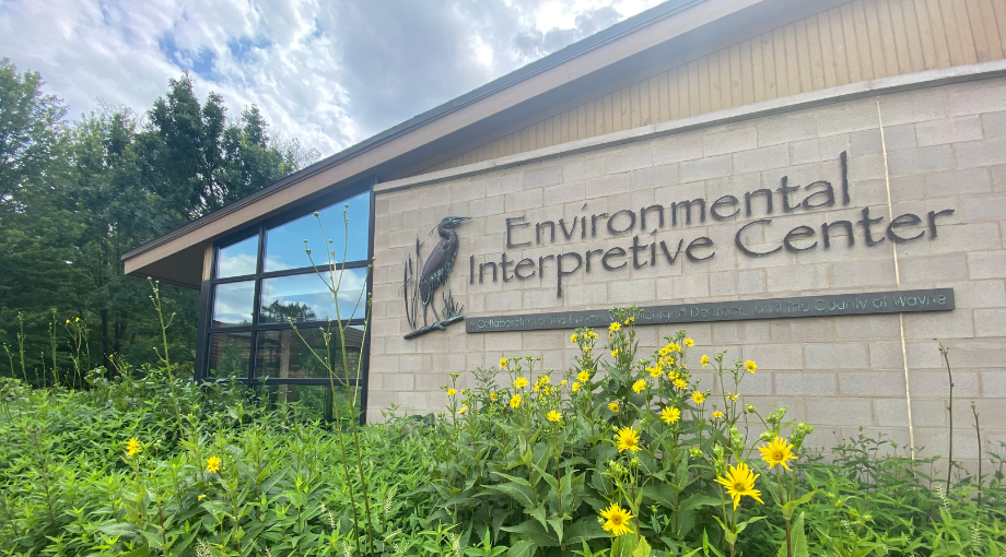 front of environmental interpretive center with yellow flowers