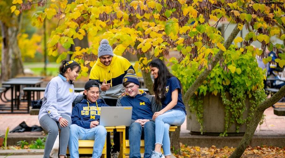 Group of students sitting by the Chancellor's Pond