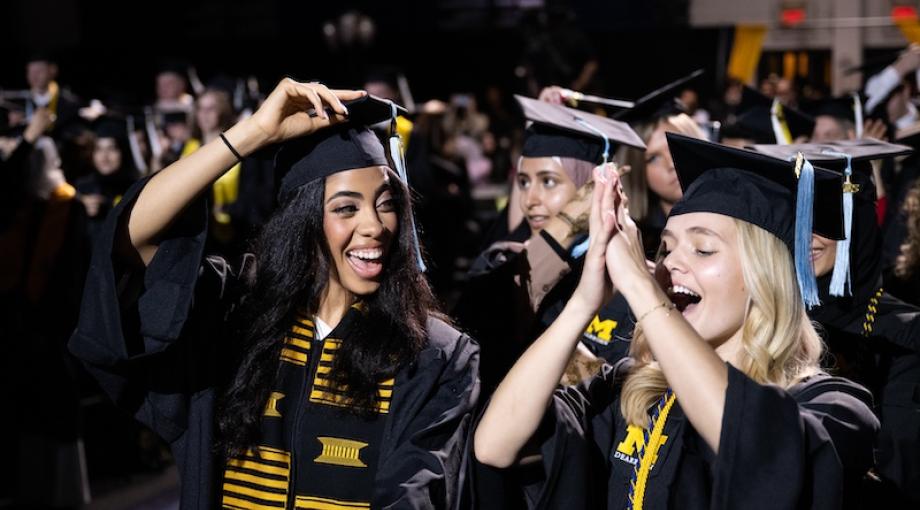 Graduates celebrating during graduation ceremony.