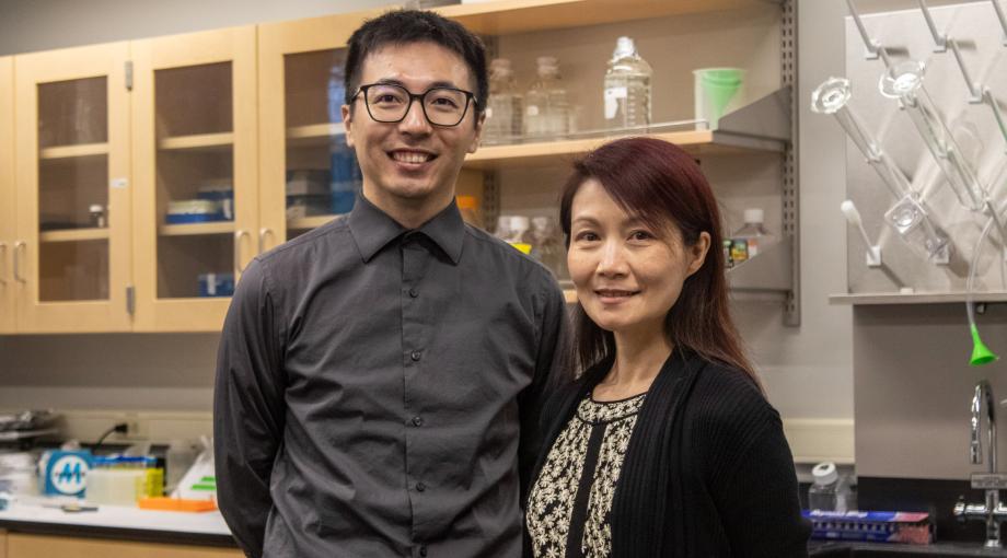 Assistant Professor Jie Fan and Associate Professor Dr. Zhi "Elena" Zhang stand for a portrait in their biology lab