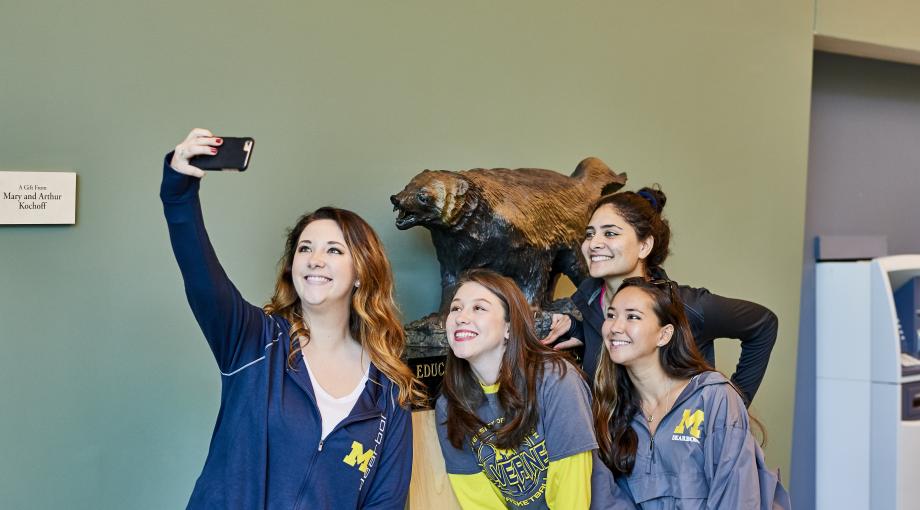 Students take selfie in front of wolverine 