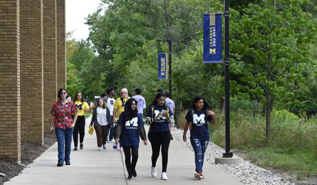 Photo of students walking on campus near the library.