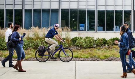 Photo of Chancellor Domenico Grasso riding his bike around campus.