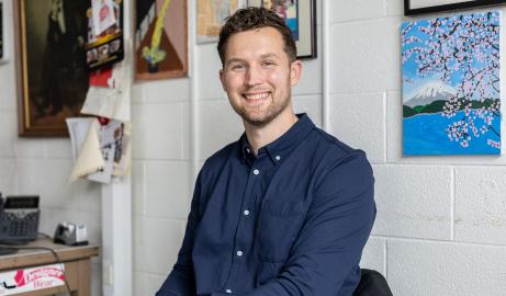 In his classroom at Oak Park middle school, Jesse Whitman poses for a seated portrait.