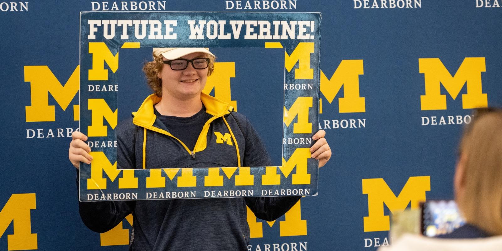 Student poses with UM-Dearborn selfie frame