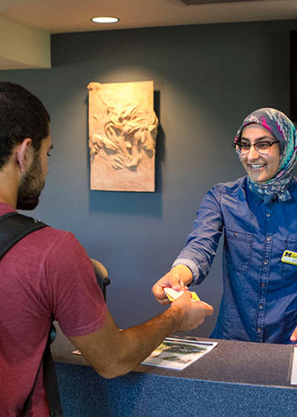 A student receiving their MCard at the University Center