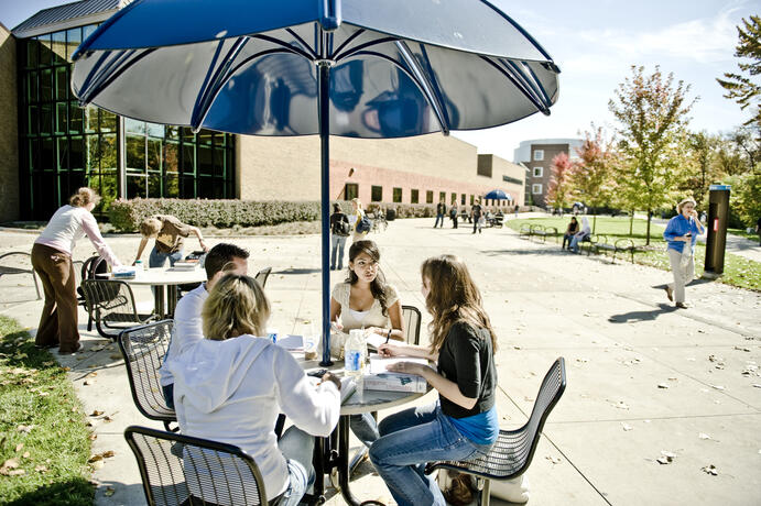 Students at the picnic tables outside the UC.