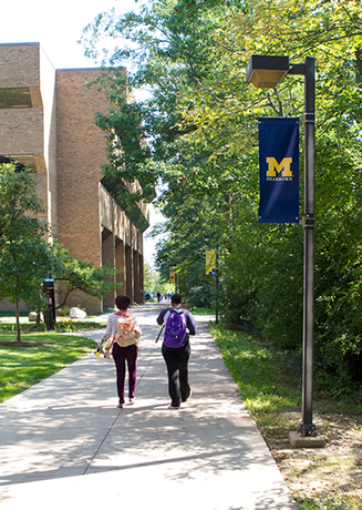 Students walking on the path outside the library.