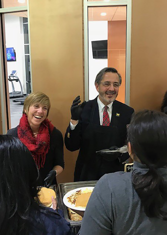 December 12, 2018: Chancellor Grasso and his wife, Susan, serve pancakes as students prepare for final exams. 