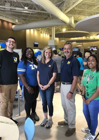 September 1, 2018: Chancellor Grasso and Dean of Students Amy Finley (center) welcome students to The Union at Dearborn during move-in day. 
