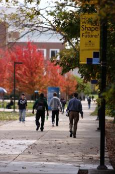 Students walking on campus in the fall