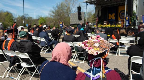 Students with families and friends seated at a commencement ceremony