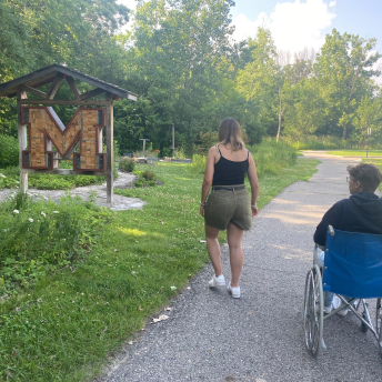 person in wheelchair on nature stroll