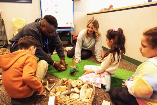Student teachers playing with children at Early Childhood Center