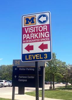 Red Visitor Parking Sign outside of MPS
