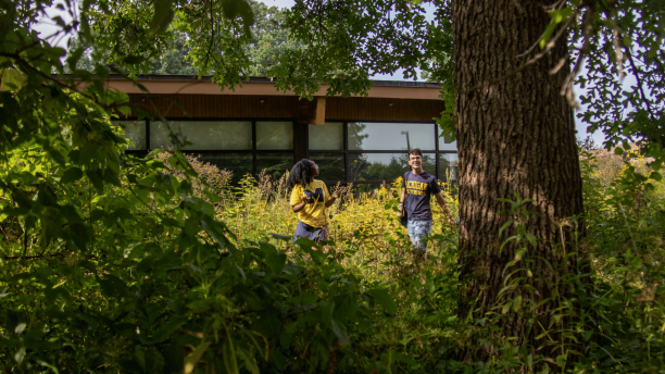 Students volunteer placing native plants around the Environmental Interpretive Center